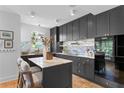 Modern kitchen with dark cabinetry, marble countertops, and island at 716 14Th Ne Ave, St Petersburg, FL 33701