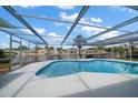 Relaxing kidney-shaped pool with screened enclosure at 3934 Venetian Way, Tampa, FL 33634