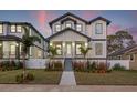 Two-story modern farmhouse with gray and white exterior, landscaping, and walkway at 125 48Th N Ave, St Petersburg, FL 33703