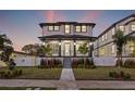 Two-story house with gray and white exterior, front porch, and landscaped yard at 135 48Th Ave, St Petersburg, FL 33703