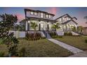 Two-story house with gray and white exterior, front porch, and landscaped yard at 135 48Th Ave, St Petersburg, FL 33703