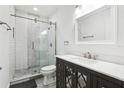 Modern bathroom with white subway tiles, a glass shower, and dark vanity at 2272 Chianti Pl # 4-0048, Palm Harbor, FL 34683