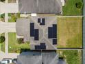 Aerial view of house roof featuring solar panels and fenced yard surrounded by neighboring homes at 12235 Creek Preserve Dr, Riverview, FL 33579