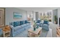 Bright living room with light blue sofa and coastal decor at 660 Island Way # 301, Clearwater Beach, FL 33767