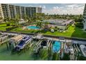 Drone shot of resort-style pool, tennis courts, and boat docks at 660 Island Way # 301, Clearwater Beach, FL 33767