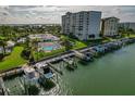 Aerial view of boat slips and waterfront property with lush landscaping at 660 Island Way # 301, Clearwater Beach, FL 33767