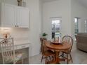 Cozy breakfast nook with wooden table and chairs, adjacent to the kitchen at 4050 Eagle Cove East Dr, Palm Harbor, FL 34685