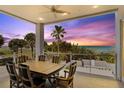 Outdoor patio with ocean views and a dining table for six at 2 4Th Ave, Indian Rocks Beach, FL 33785