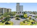 Building exterior showcasing landscaping and parking at 660 Island Way # 401, Clearwater, FL 33767