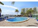 Community pool with lounge chairs and nearby building at 660 Island Way # 401, Clearwater, FL 33767