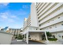 A covered condo entrance with well-maintained landscaping provides a welcoming arrival experience at 7000 Beach Plz # 505, St Pete Beach, FL 33706