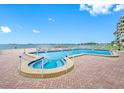 Relaxing waterfront pool and spa area at 300 Woodette Dr # 202B, Dunedin, FL 34698