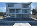 Modern three-story waterfront home featuring a covered patio on the second floor at 2121 Bayou Grande Ne Blvd, St Petersburg, FL 33703