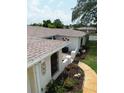 Aerial view of a well-maintained home featuring a new roof, lush landscaping, and a quaint front patio at 1172 Chelsea Ln, Holiday, FL 34691