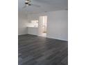 A bright living room with gray flooring that opens into the kitchen space at 2700 Bayshore Blvd # 559, Dunedin, FL 34698