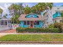 Charming light blue bungalow with colorful landscaping and brick walkway at 407 10Th Ne Ave, St Petersburg, FL 33701