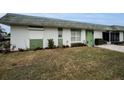 House exterior showcasing a green door and surrounding greenery at 7787 39Th N Ter # 7787, St Petersburg, FL 33709