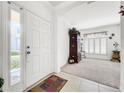 Bright entryway with tile flooring, decorative accents, and views to other rooms at 2325 Pleasant Hill Ln, Holiday, FL 34691