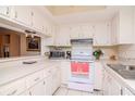 Bright kitchen with ample counter space and white cabinets at 2400 Winding Creek Blvd # 25-101, Clearwater, FL 33761