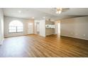 Bright living room with wood-look floors and a ceiling fan at 10608 Bucks Run, New Port Richey, FL 34654