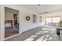 Bright living room with gray herringbone floors, white shiplap walls, and large windows offering natural light at 4132 4Th S St, St Petersburg, FL 33705