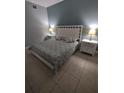 Bright bedroom with a king-size bed and two nightstands at 6734 Dali Ave # B102, Land O Lakes, FL 34637