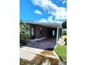 Mobile home with covered patio and brick pavers at 283 Pelican N Dr, Oldsmar, FL 34677