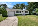 Well-maintained home featuring a green lawn and attached single-car garage at 707 2Nd Se St, Largo, FL 33771