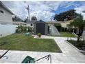 Landscaped backyard with shed and patio at 1847 Oak Lake Dr, Clearwater, FL 33764