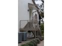 Exterior stairs leading to condo entry with metal railings and AC units below at 635 Fairmont Ave # D, Safety Harbor, FL 34695