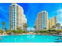 A stunning waterfront pool sits between high-rise buildings under a clear blue sky at 1170 Gulf Blvd # 1005, Clearwater Beach, FL 33767