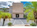 Shore Plaza condo building entrance with palm trees and walkway at 1893 Shore S Dr # 206, South Pasadena, FL 33707