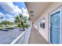Condo hallway with light-colored walls and white railings at 1893 Shore S Dr # 206, South Pasadena, FL 33707