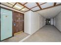 Interior hallway with access to unit and building amenities at 3021 Countryside Blvd # 28A, Clearwater, FL 33761