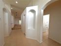 Bright hallway with tile flooring, neutral walls, and access to other rooms at 31207 Chatterly Dr, Wesley Chapel, FL 33543