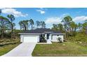 Single-story house with a grey exterior and a spacious yard at 9333 Hialeah Ter, Port Charlotte, FL 33981