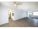 Open living room with herringbone floors and view into kitchen at 17734 1St E St, Redington Shores, FL 33708