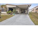 Covered carport with golf cart and well-maintained landscaping at 37527 El Sol Ave, Zephyrhills, FL 33541