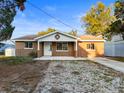 Charming single story home with a unique stucco exterior, decorative front entrance, and spacious driveway at 13912 Sommers Ave, Hudson, FL 34667