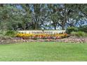 Community entrance sign with landscaping, welcoming residents to Timber Pines at 2241 Merion Ct, Spring Hill, FL 34606