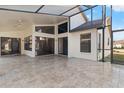 Large covered patio with tile flooring and screened enclosure at 9131 Haas Dr, Hudson, FL 34669