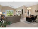 Spacious living room featuring a comfortable seating area and a home office space at 11724 Heritage Point Dr, Hudson, FL 34667