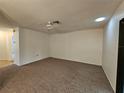 Spacious living room featuring carpet, a ceiling fan, and access to other rooms at 6592 Brambleleaf Dr, Spring Hill, FL 34606