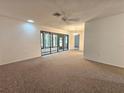 Open living area with view into dining room and access to patio at 6592 Brambleleaf Dr, Spring Hill, FL 34606