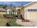 Front entrance with a landscaped walkway leading to the house at 1153 Dustan Pl, Trinity, FL 34655