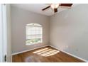 Cozy bedroom with hardwood floors, a window providing natural light, and neutral-colored walls at 2529 Sandy Hill Ct, Holiday, FL 34691
