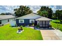 Charming home with well-manicured lawn, decorative water feature, and fresh landscaping, inviting curb appeal at 3178 Sea Grape Dr, Hernando Beach, FL 34607