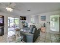 Bright and airy living room with tile floors, large windows, and comfortable seating for relaxing at 3178 Sea Grape Dr, Hernando Beach, FL 34607