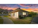 Updated one-story home with landscaped yard at sunset at 4321 Tahitian Gardens Cir # A, Holiday, FL 34691