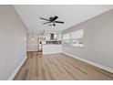 Light and airy living room with wood-look floors and ceiling fan at 4321 Tahitian Gardens Cir # A, Holiday, FL 34691